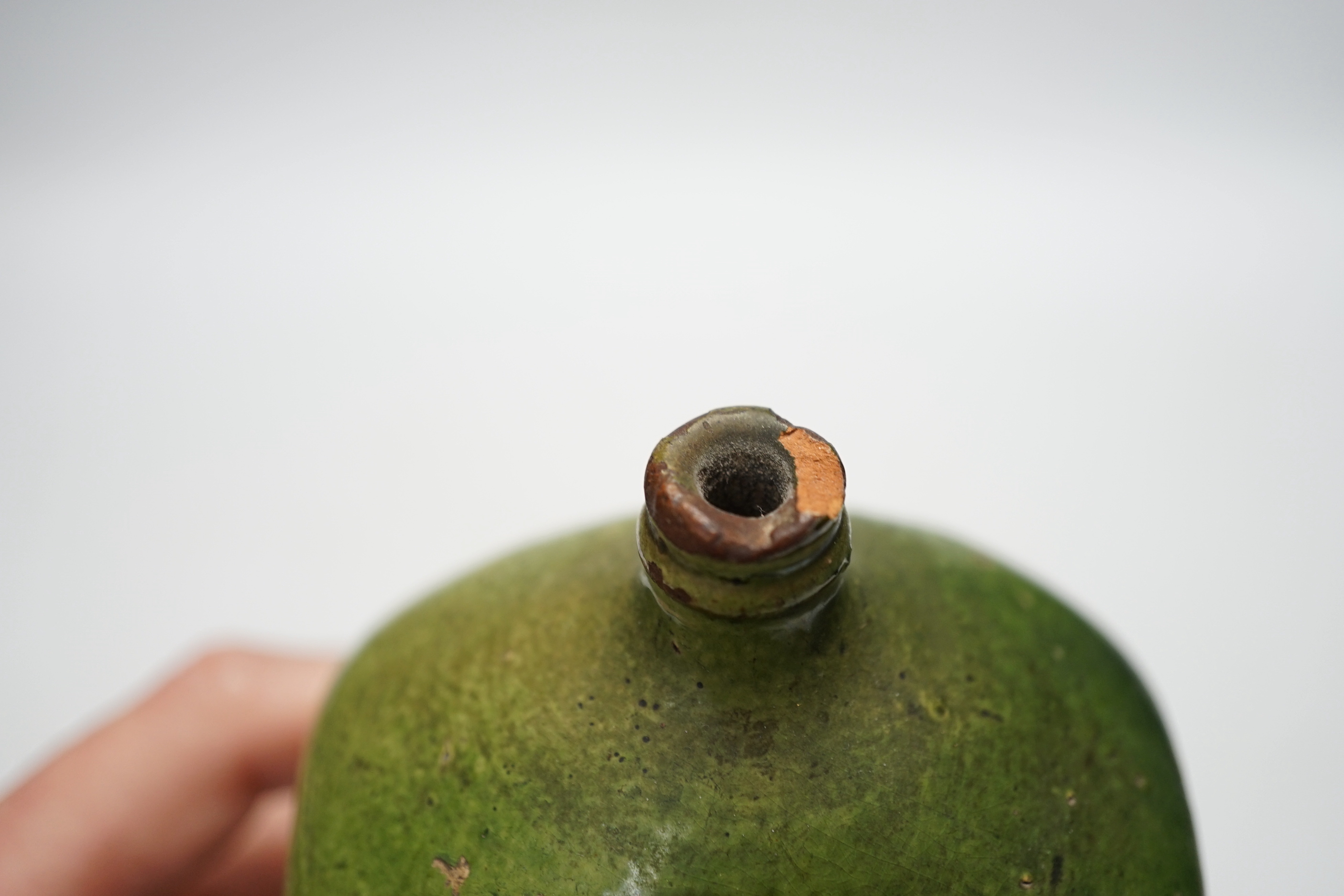 A 19th century green glazed terracotta sgraffito flask, 19cm